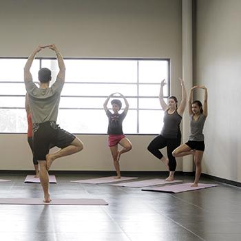 An instructor teaches a yoga class