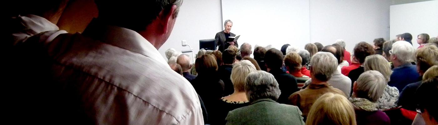 Linden MacIntyre reading to a group of people