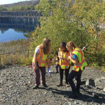 two students and a teaching assistant sampling mine tailings in the field