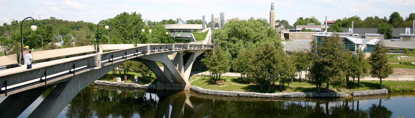 Faryon bridge and the buildings on the east bank of Trent University on a sunny day