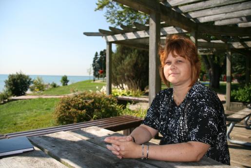 Alumna Laura Suchan by the water at the Oshawa Museum, where she is the executive director