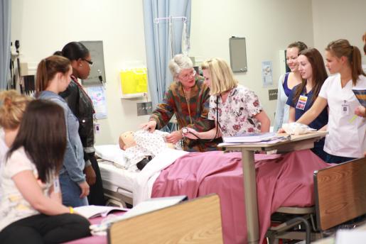 Dean of the Trent/Fleming School of Nursing, Dr. Kirsten Woodend works with students in a simulation lab