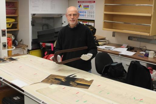 Douglas Stenton holding the davit that was the key piece of evidence leading to the 2014 discovery by Parks Canada of the wreck of one of Sir John Franklin’s ships. Courtesy of Government of Nunavut.
