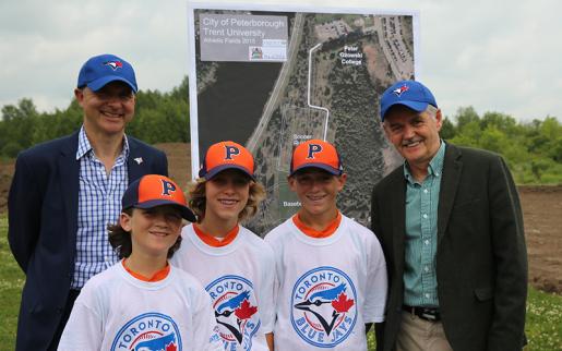 Robert Witchel, executive director of the Jays Care Foundation, members of the Peterborough Tigers Baseball Association and Trent University president and vice-chancellor Dr. Leo Groarke 