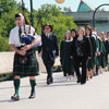 Class of 2012 convocation procession walking across the faryon bridge