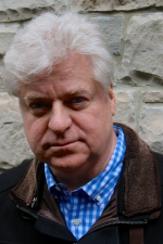 Head and shoulders photo of Linwood Barclay smiling ath the camera