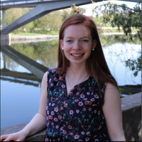 A woman smiling in front of the Otonabee River