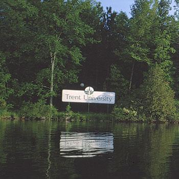 View of sign from across the river, text says Trent University