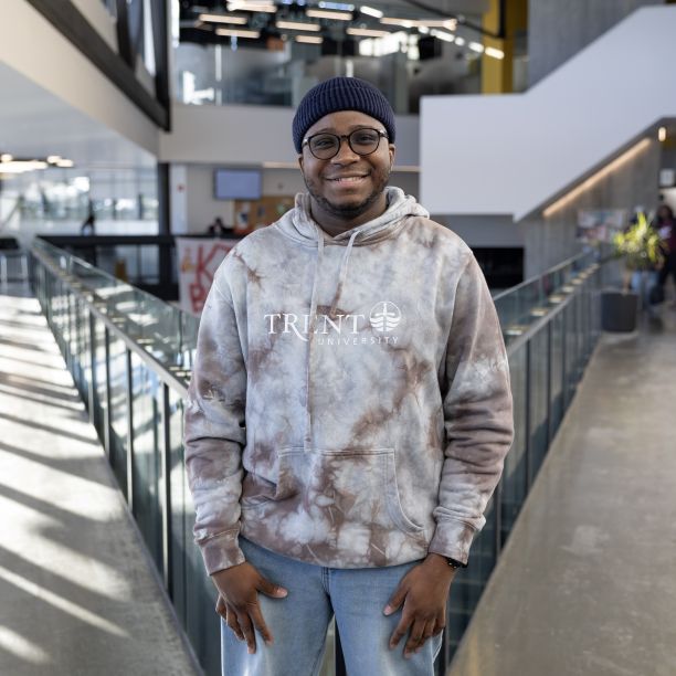 Tafadzwa, a transfer student, standing on the upper level of Trent’s Student Centre 