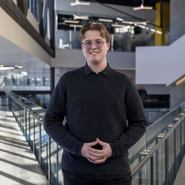 Martin, a transfer student, standing on the upper level of Trent’s Student Centre 