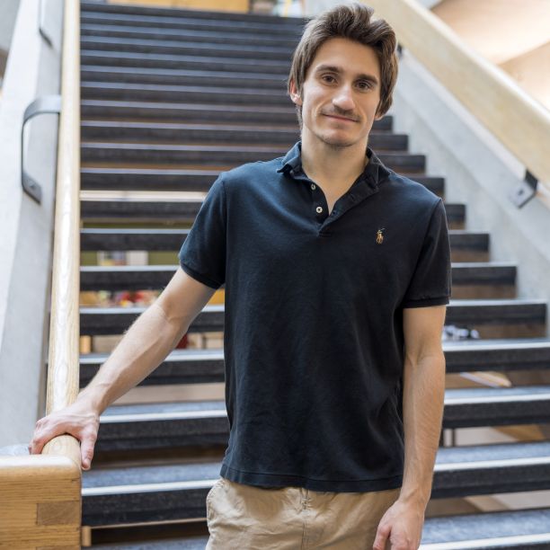 Jessie, a transfer student, standing at the base of a staircase in Trent’s Bata Library 
