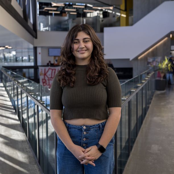 Katia, a transfer student, standing on the upper level of Trent’s Student Centre 