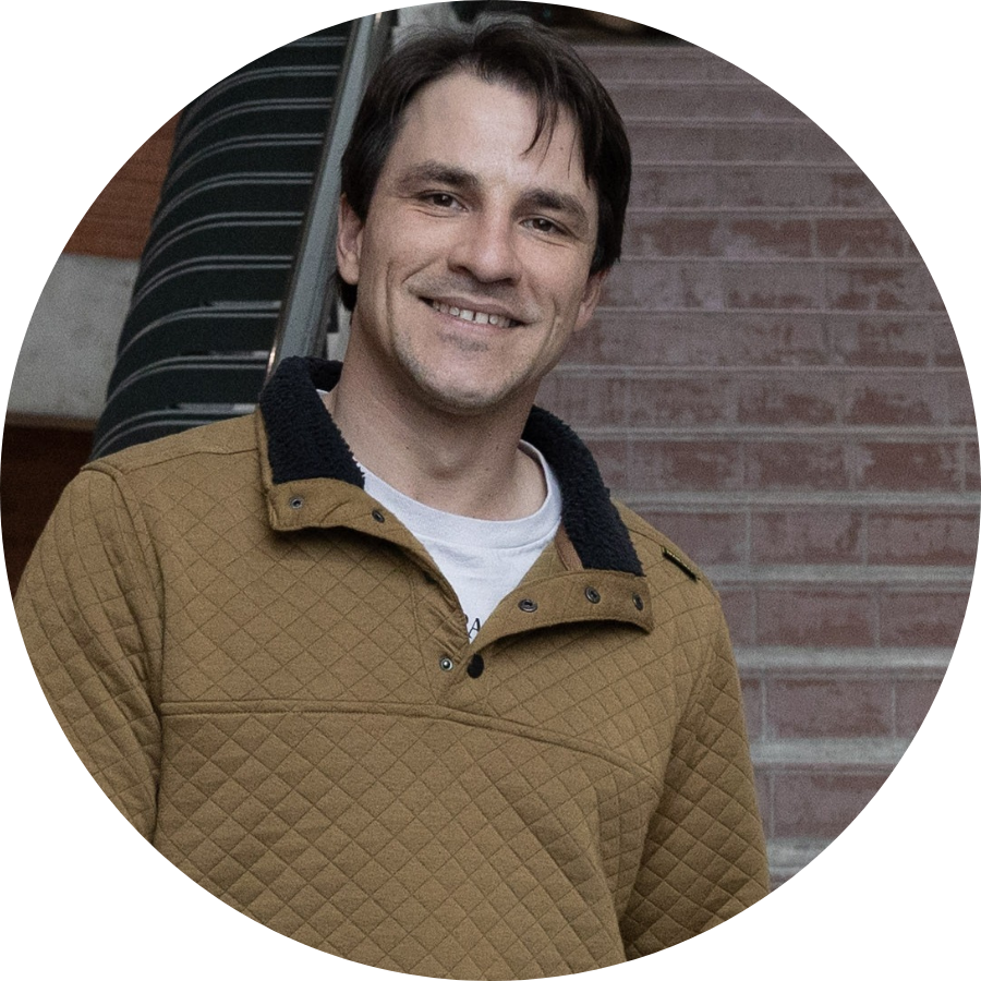 Daniel, a transfer student, standing at the base of a staircase in Trent’s Environmental Science Building 