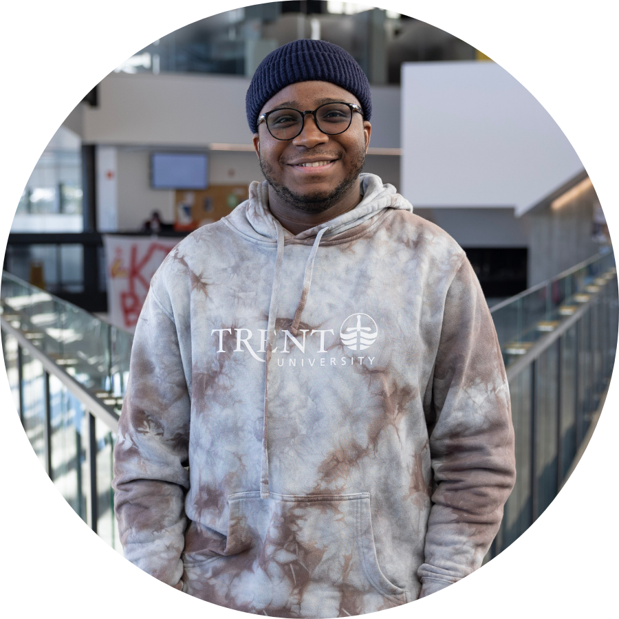 Tafadzwa, a transfer student, standing on the upper level of Trent’s Student Centre 