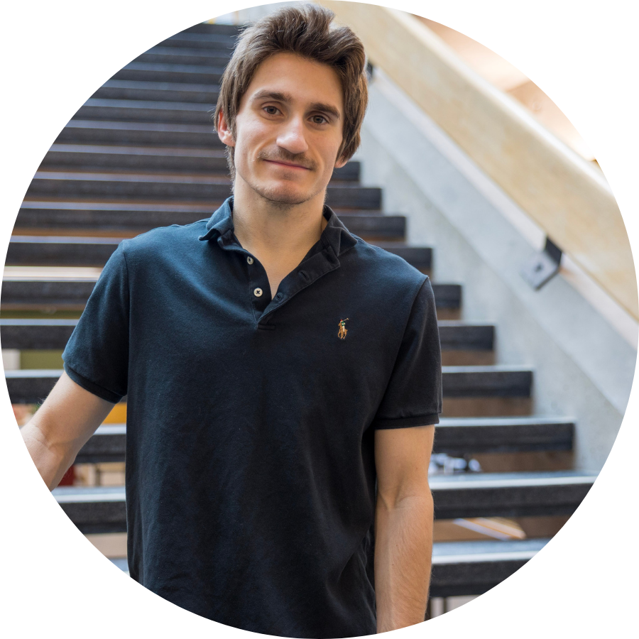 Jessie, a transfer student, standing at the base of a staircase in Trent’s Bata Library 