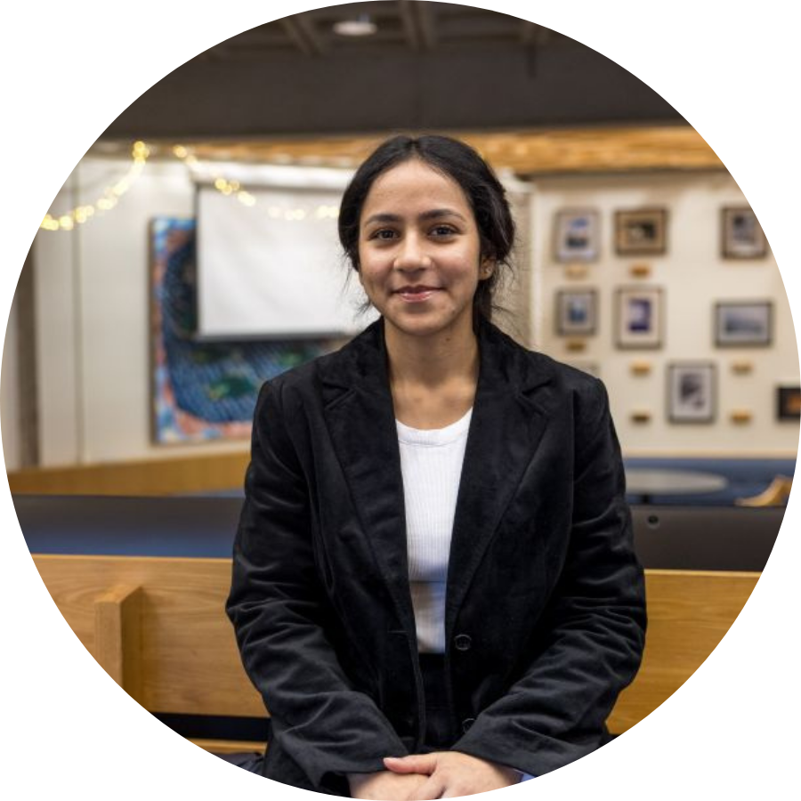 Tamanna, a transfer student, seated on a wooden bench in a student space on Trent’s Campus 