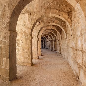 archways of the coliseum leading down a tunnel