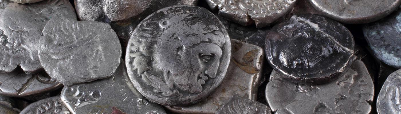 old roman coins made of silver piled on top of each other