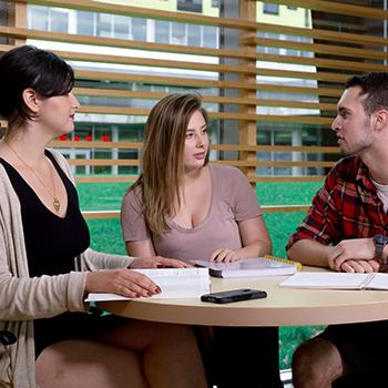 anthropology graduate students sit and discuss in Gzowski College at Trent University