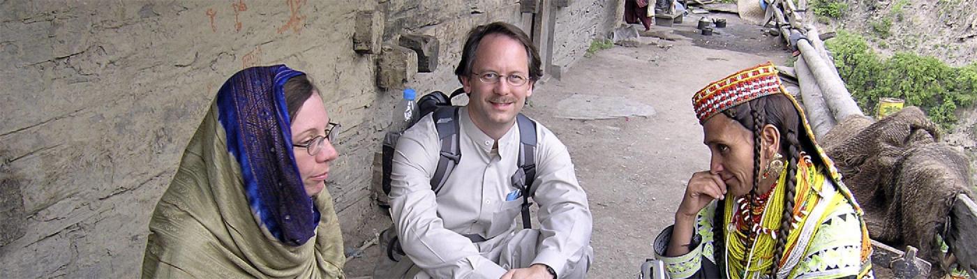 Prof Roger Lohmann and U of T Prof Heather Miller, seated with woman from Kalash Valleys, Pakistan 2005