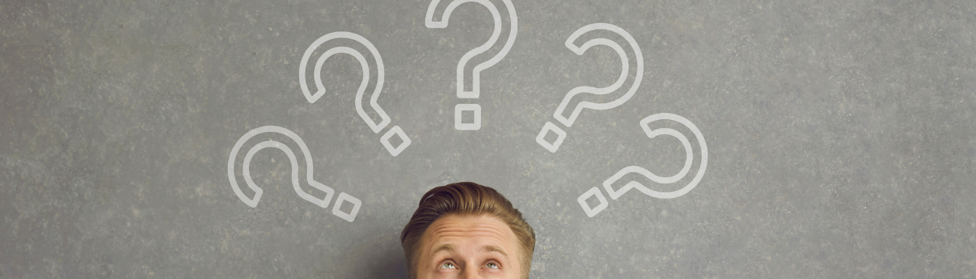 Man looking upwards with question marks over his head