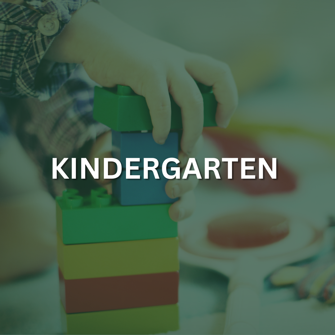 A hand of a small child is playing with building blocks