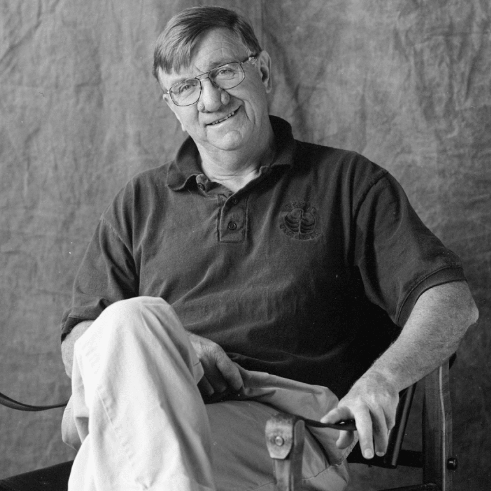 black and white photo of Paul Wilson sitting in a chair