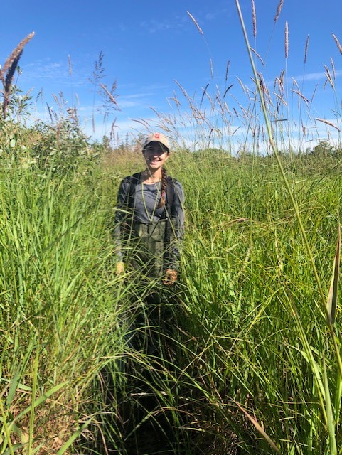 Student in grassy field