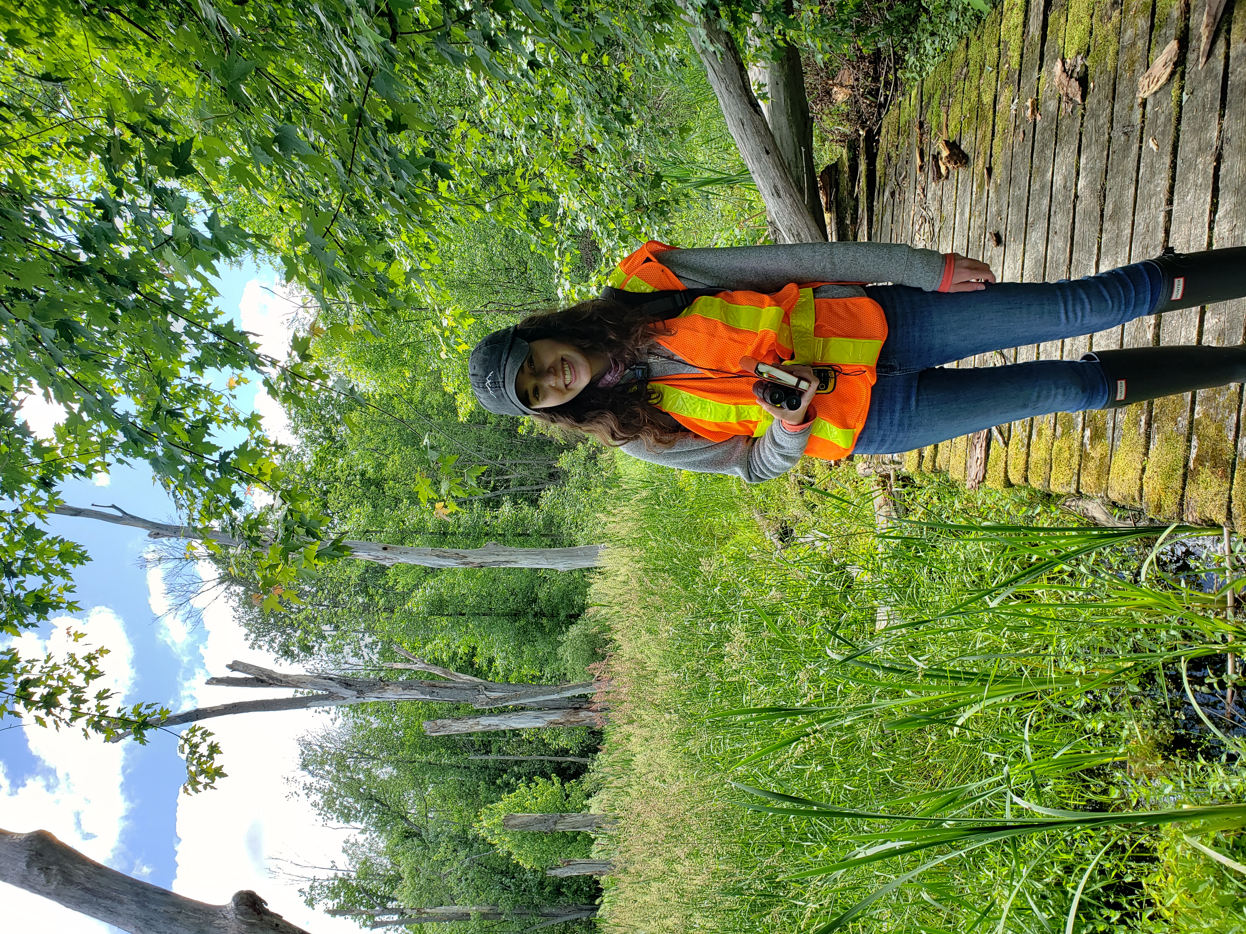 Student on boardwalk in forest