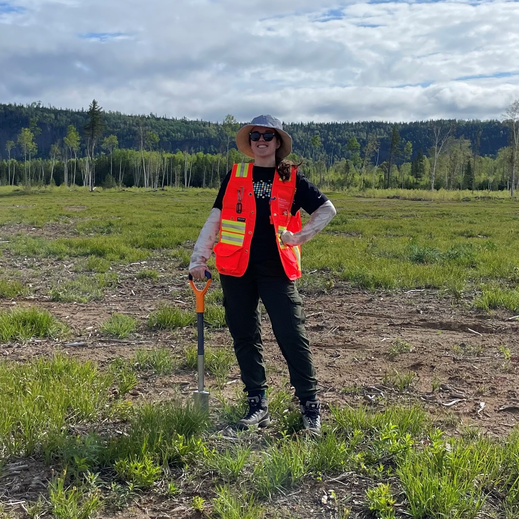 student with shovel near forest