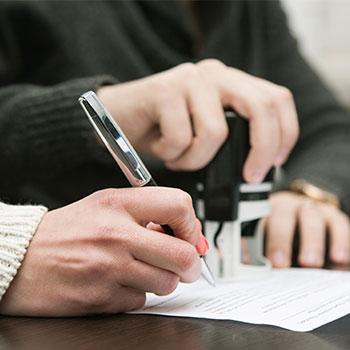 a lady signing a contract