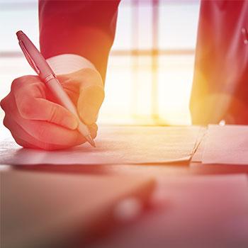 Closeup of man signing paper