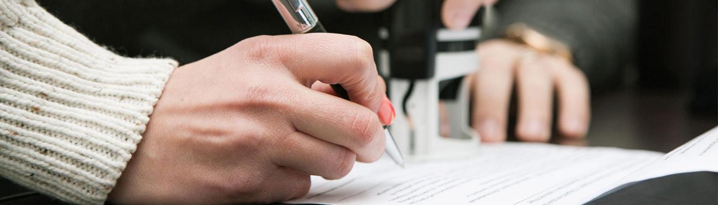 a lady signing a contract