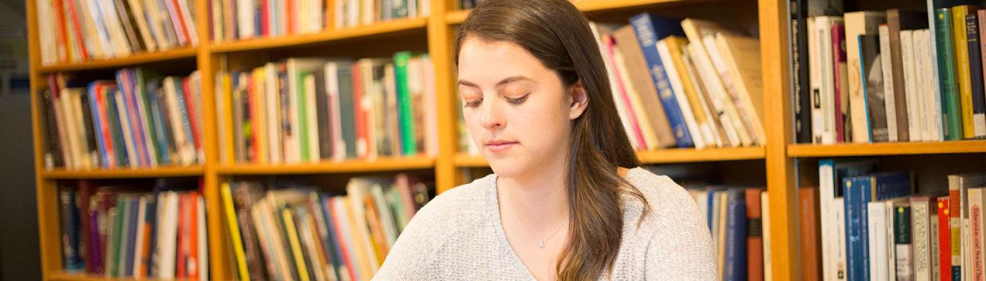 Girl sitting at desk in library