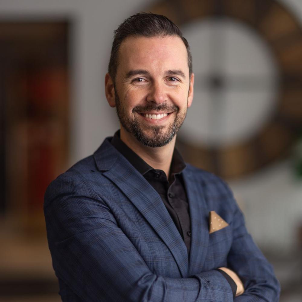 Bob standing, arms crossed and smiling 