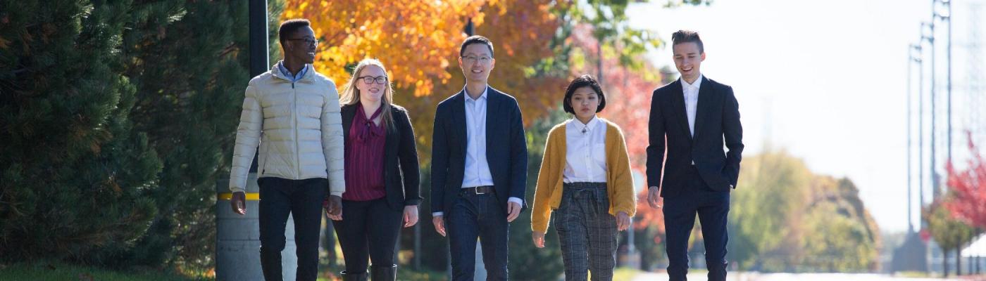 Five Business School students walking together near the Trent Durham campus