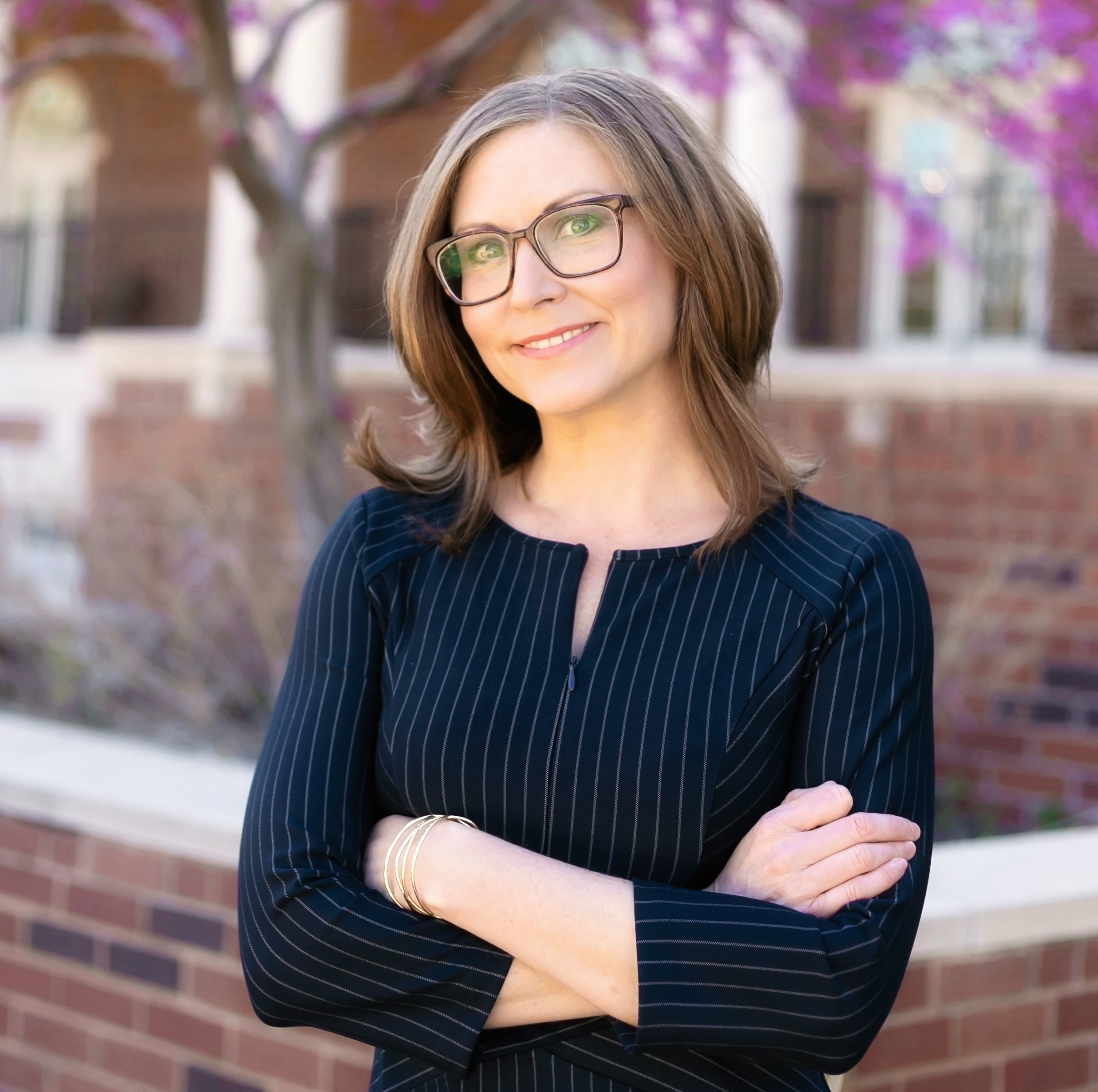 smiling human with glasses facing camera
