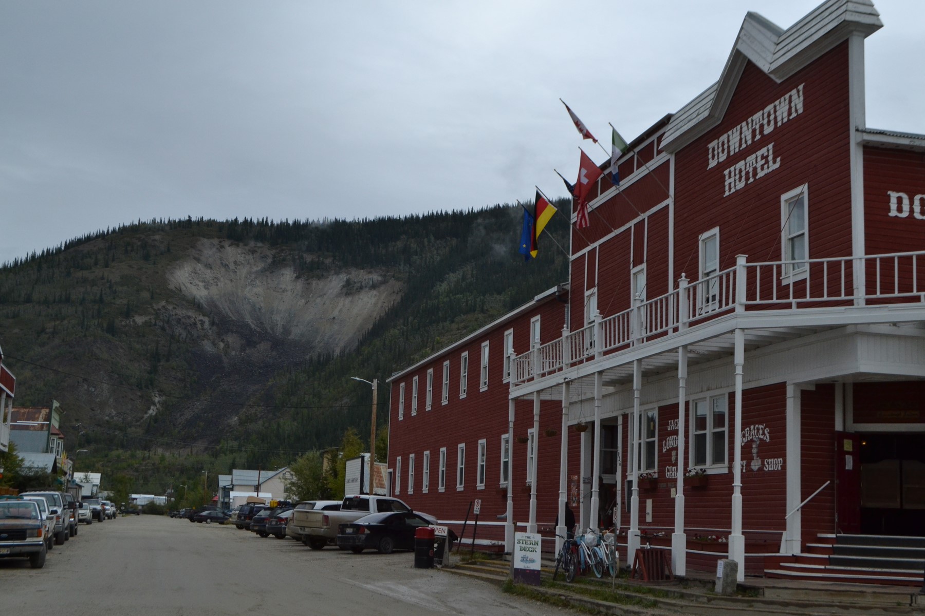 Front fascade of older style hotel with foothills in background