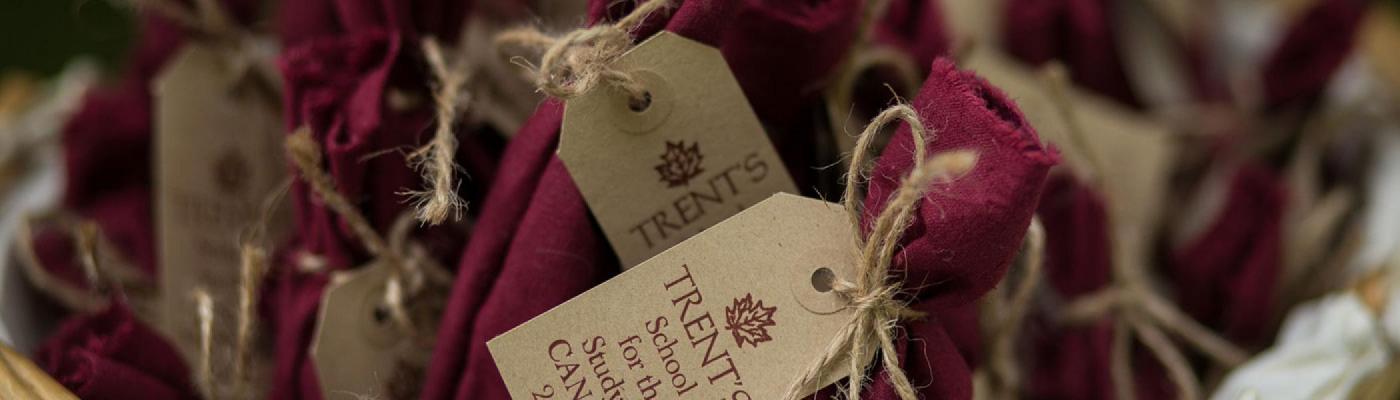 Basket of red bundles with School for the Study of Canada tags