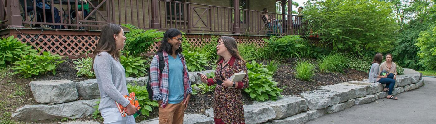 Students and faculty in discussion outside Kerr House, Traill College