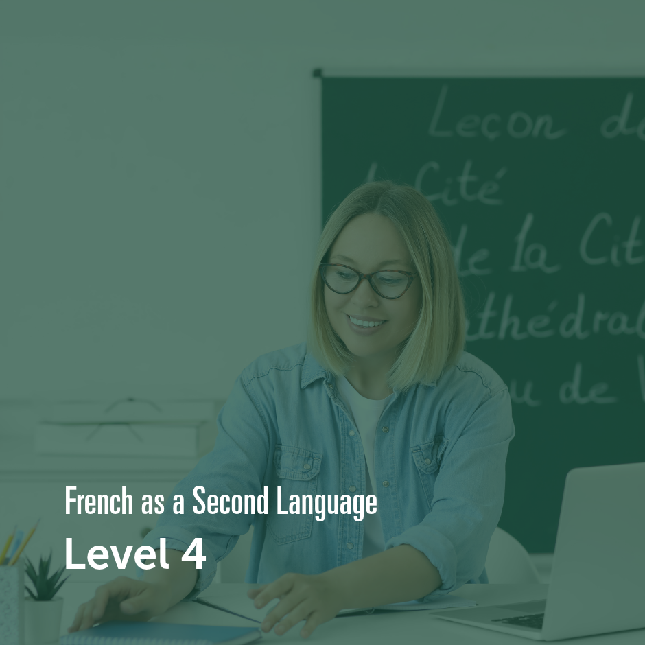 Learner studying French in a classroom with a laptop and French lesson board.