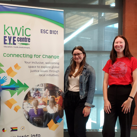 Co-op Student Abbey standing next to KWIC Banner during work term