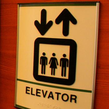 Elevator with elevator sign beside it