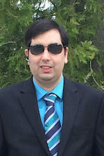 Brian Srivastava wearing a black suit and dark sunglasses