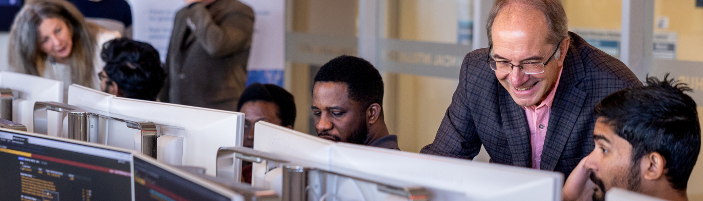 students in computer lab with faculty