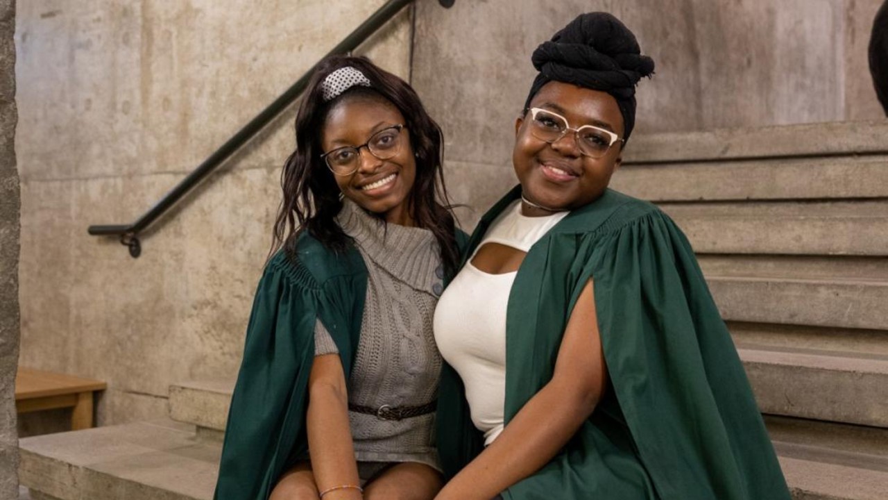 Two students sitting on the stairs