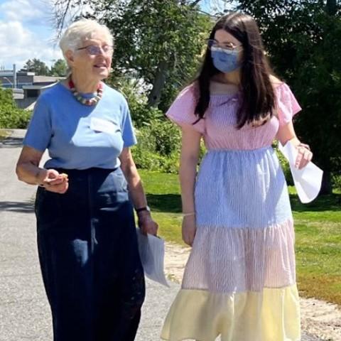 A student walking with an older adult