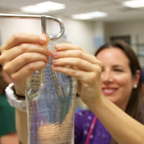 A nurse hanging an IV bag