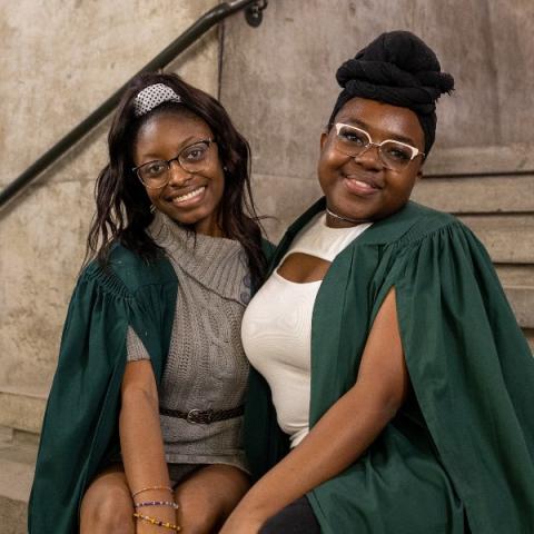 Two students sitting together in the Great Hall