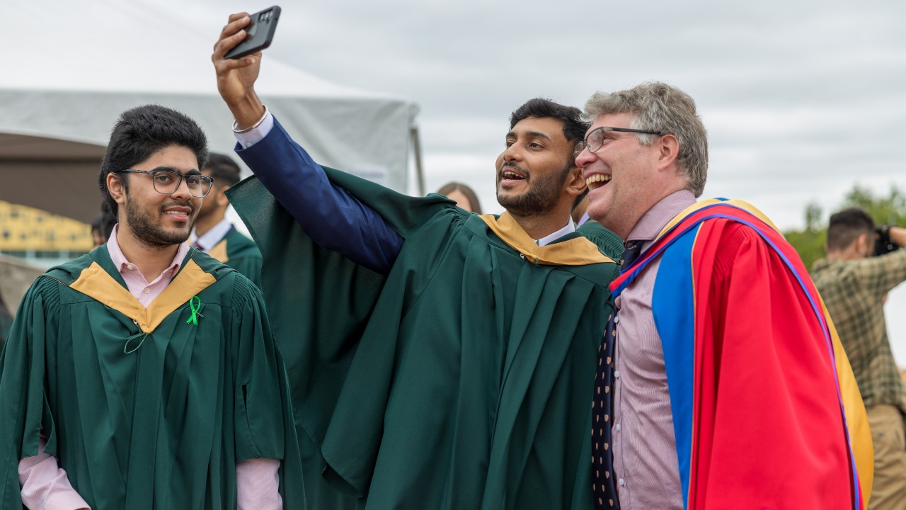 Dr. Michael Eamon with two graduating students